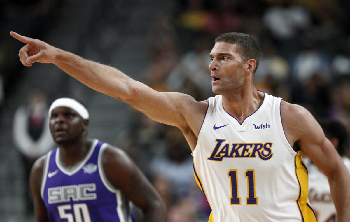 Los Angeles Lakers center Brook Lopez (11) points to the fans after a basket against the Sacramento Kings during the first half of a preseason NBA basketball game at the T-Mobile Arena, Sunday, Oct. 8, 2017, in Las Vegas.