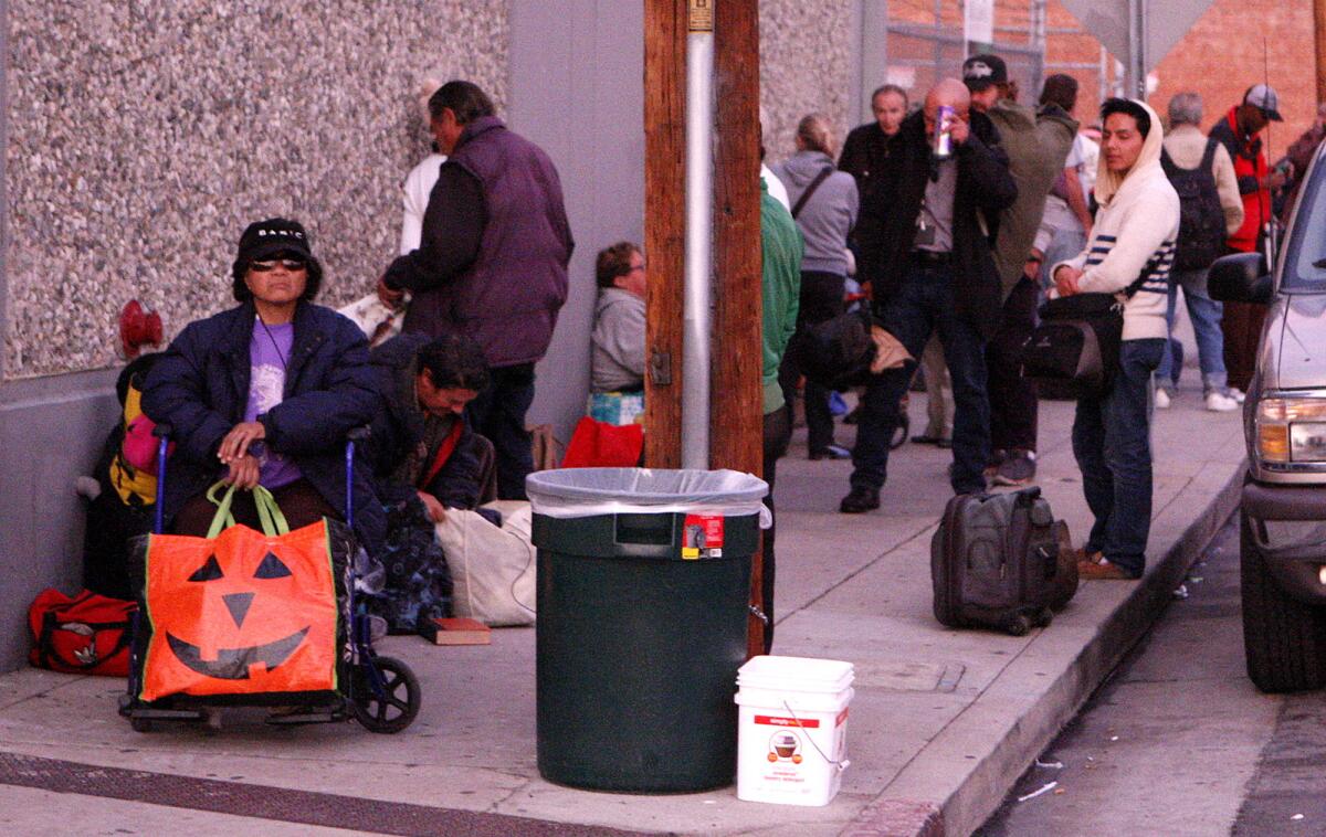 People wait in line for the shelter to open at Ascencia in Glendale for the Glendale Winter Shelter Program on Monday, December 2, 2013.