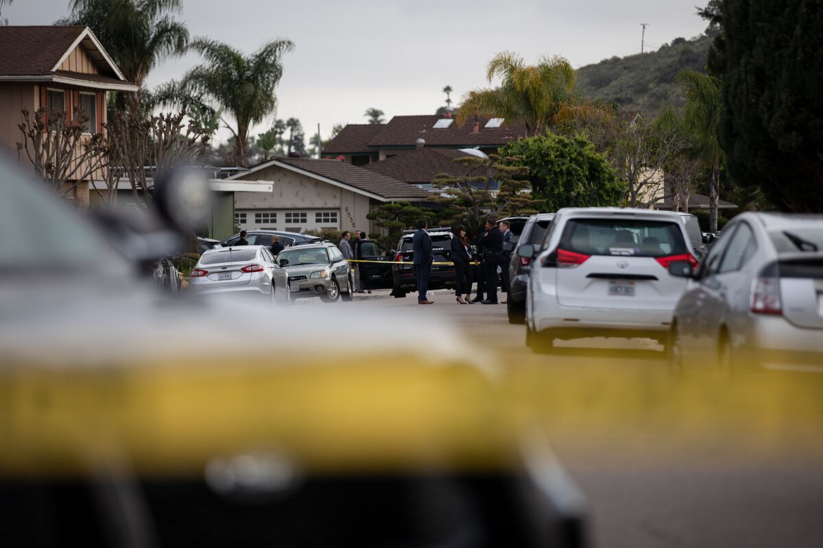 Authorities are seen in the San Carlos neighborhood near where SDPD shot a man on Wednesday, March 30, 2022.