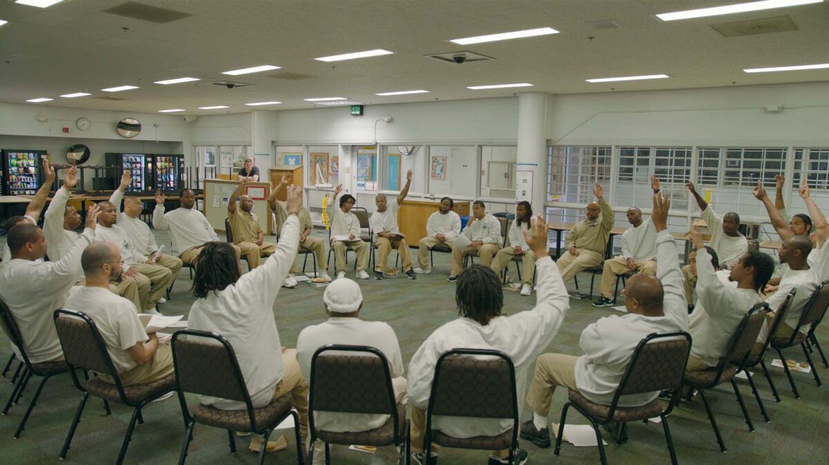 Two dozen inmates sitting in a circle in the documentary "Since I Been Down."
