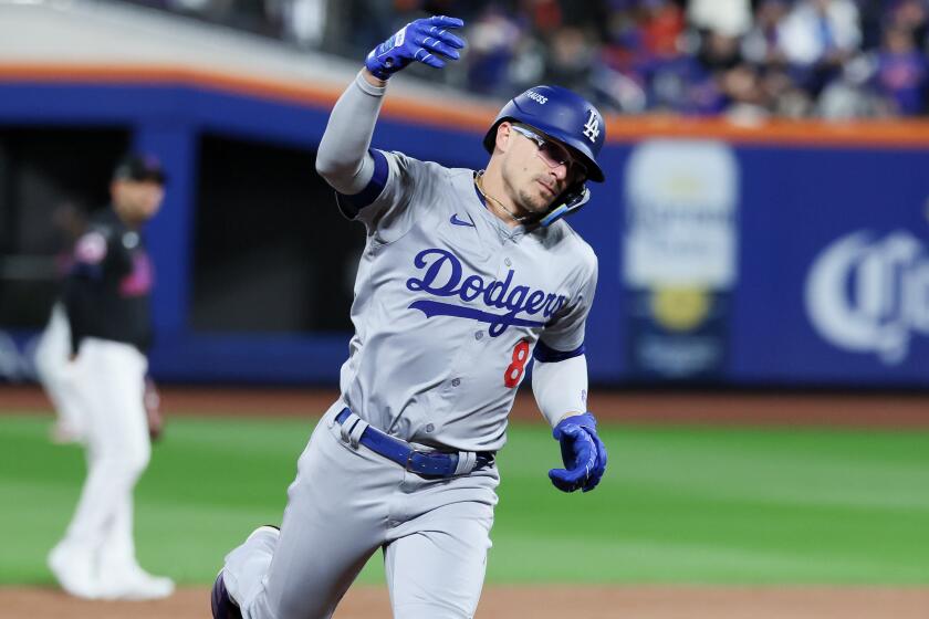 Kiké Hernández celebrates after hitting a two-run home run for the Dodgers in the sixth inning against the New York Mets.