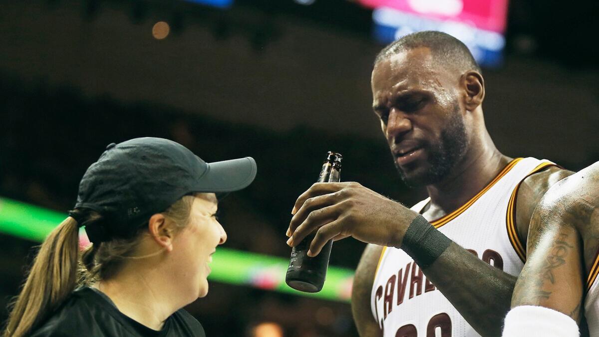 Cleveland's LeBron James ends up with a beer bottle in his hand during the third quarter of the Cavaliers' victory over the Toronto Raptors on May 1.