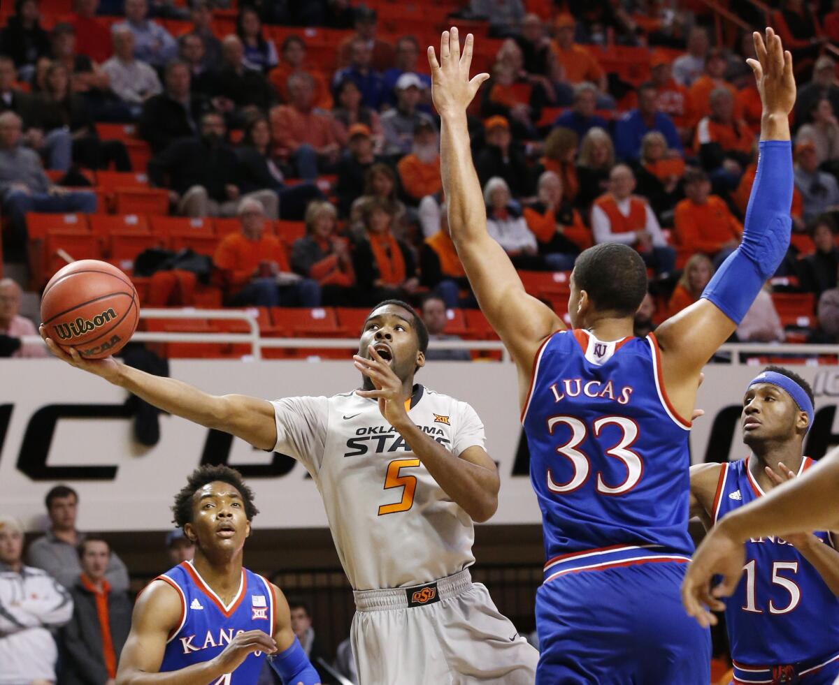 Oklahoma State guard Tavarius Shine shoots in front of Kansas forward Landen Lucas during the first half of a game on Jan. 19.