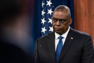 Secretary of Defense Lloyd Austin listens to a reporter's question during a media briefing at the Pentagon