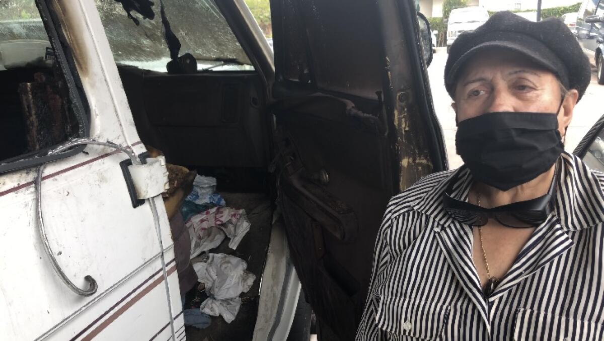 Consuelo “Conny” Gómez no puede ocultar el quebranto al mostrar su vehículo vandalizado en Boyle Heights.