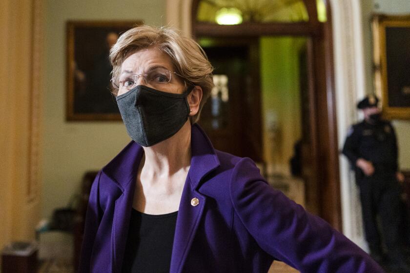 Sen. Elizabeth Warren, D-Mass., speaks to a reporter on Capitol Hill in Washington, Tuesday, Dec. 7, 2021.(AP Photo/Carolyn Kaster)