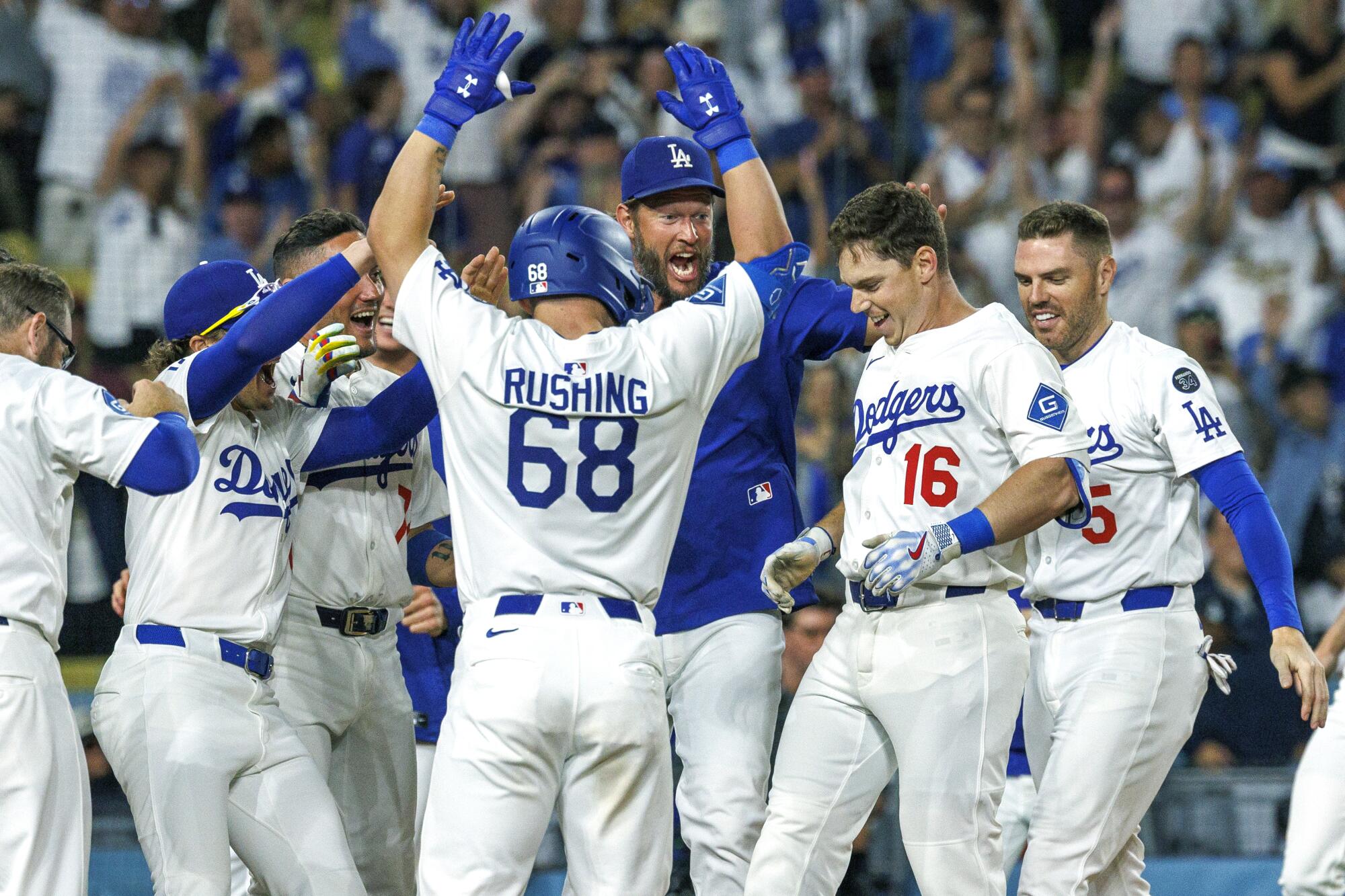 Will Smith (16) celebrates with his Dodgers teammates after hitting a walk-off home run.