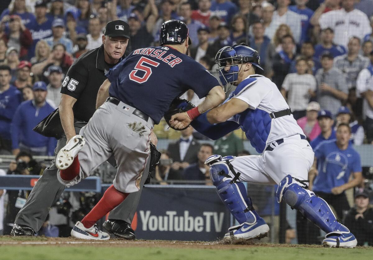 Ian Kinsler is tagged out by Dodgers catcher Austin Barnes on a throw from outfielder Cody Bellinger to end the top of the 10th inning.