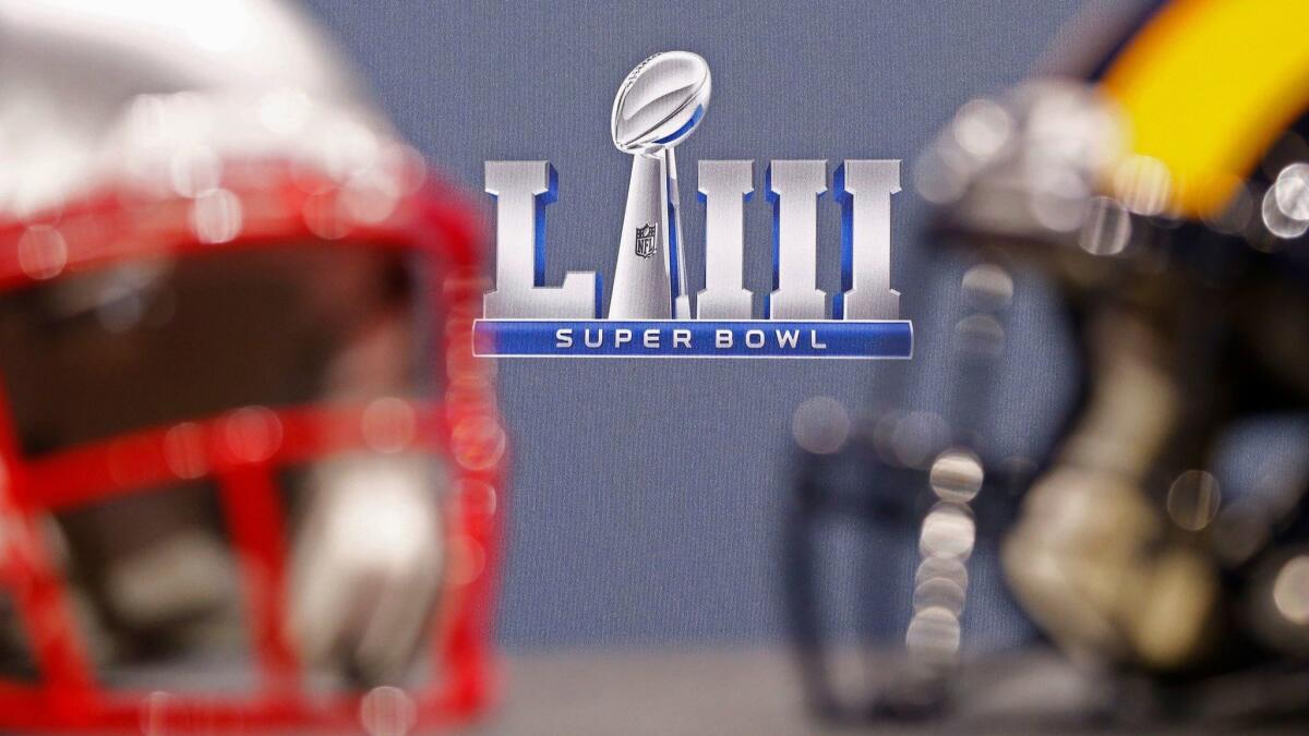 The LA Rams and New England Patriots helmets sit on stage at NFL commissioner Roger Goodell's press conference in Atlanta, Ga. on Jan. 30.