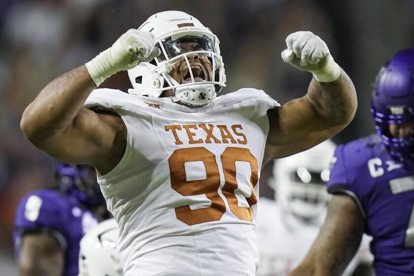 FILE - Texas defensive lineman Byron Murphy II (90) celebrates after a sack against TCU quarterback Josh Hoover in the first half of an NCAA college football game, Saturday, Nov. 11, 2023, in Fort Worth, Texas. Murphy has been mentioned as a possible NFL Draft first round pick by the Cincinnati Bengals. (Ricardo B. Brazziell/Austin American-Statesman via AP, File)