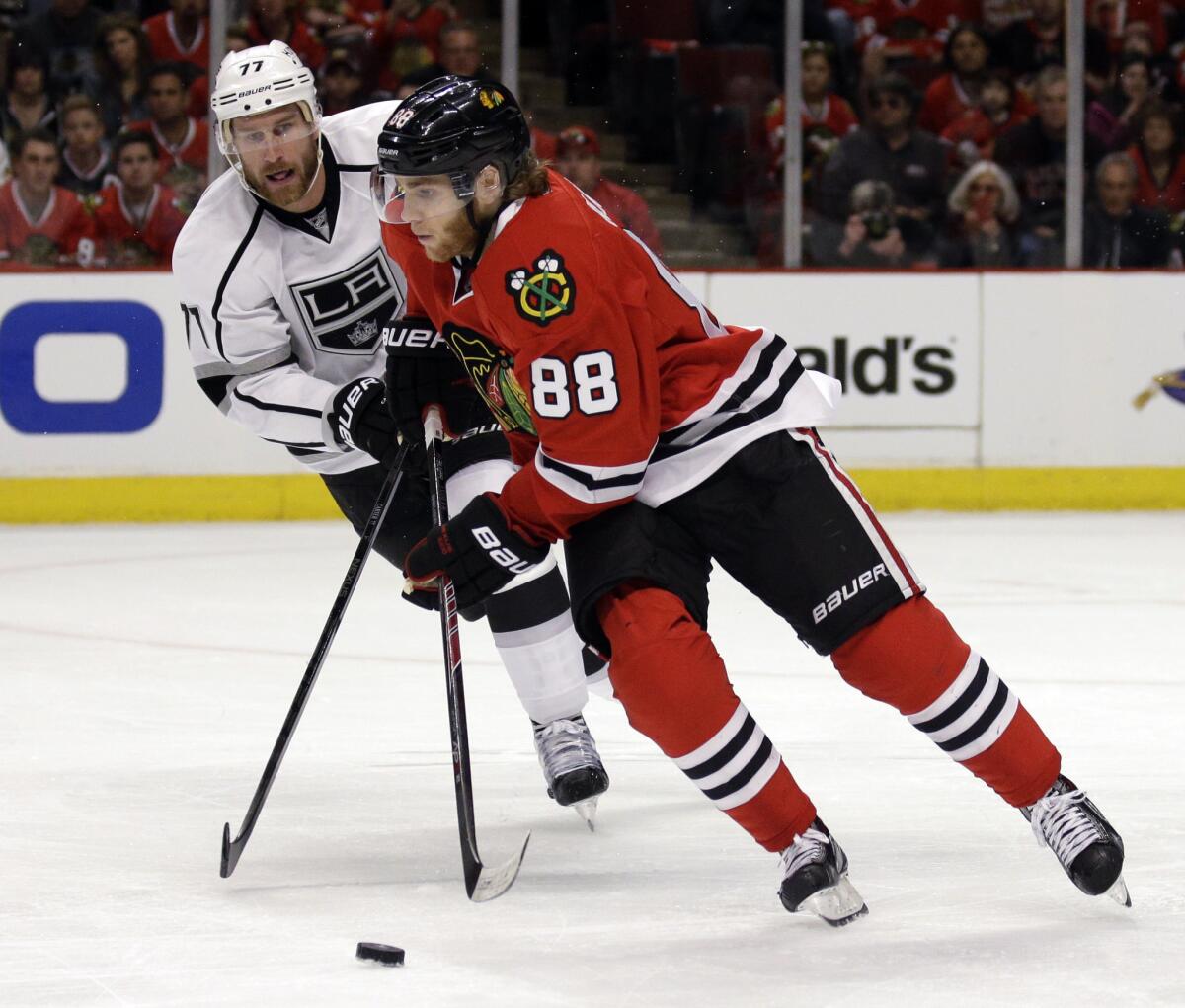 Patrick Kane of the Blackhawks, front, says all the pressure is on Jeff Carter and the rest of the L.A. Kings.