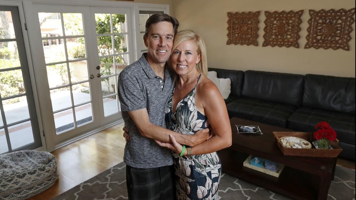 John Ward and wife, Christy, in their Newport Beach home on July 6. John recently had a kidney transplant after being diagnosed with a rare blood disease that affects the kidneys. The kidney came from his wife, Christy, who was considered “barely a match.”