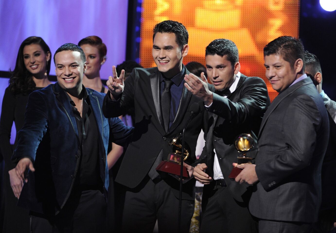 Banda Los Recoditos accept the award for best banda album for "El Free."