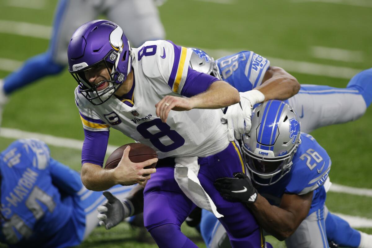 Minnesota Vikings quarterback Kirk Cousins is sacked by Detroit Lions safety Duron Harmon.