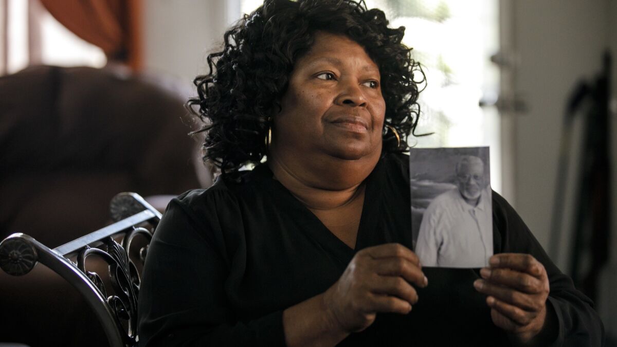 Rosie Harmon holds a photo of brother Bobby Joe Maxwell, whose 1984 murder convictions were overturned decades later.