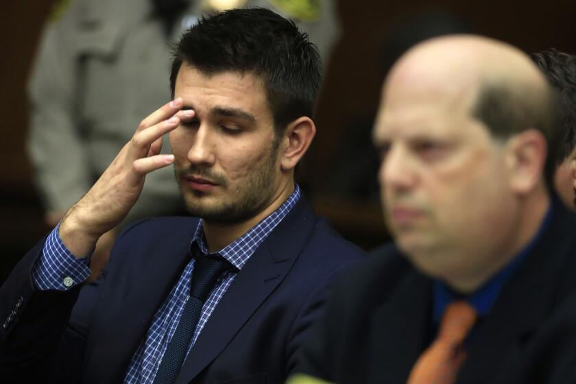 Kings defenseman Slava Voynov, left, attends his arraignment last December in Los Angeles County Superior Court in Torrance.