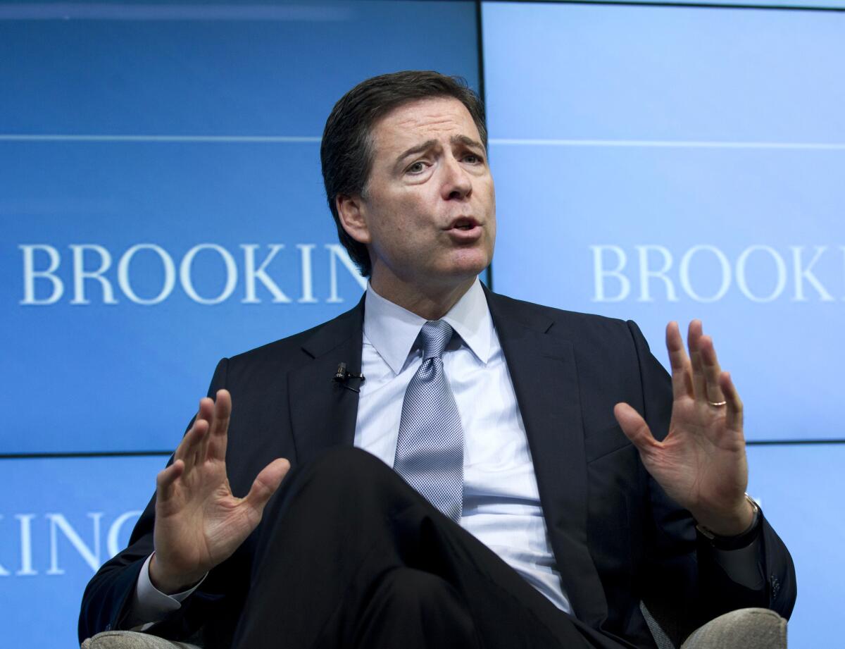 FBI Director James Comey speaks about the impact of technology on law enforcement at the Brookings Institution in Washington on Thursday. Comey gave a stark warning against smartphone data encryption, saying homicide cases could be stalled, suspects could go free and "justice may be denied because of a locked phone or an encrypted hard drive."