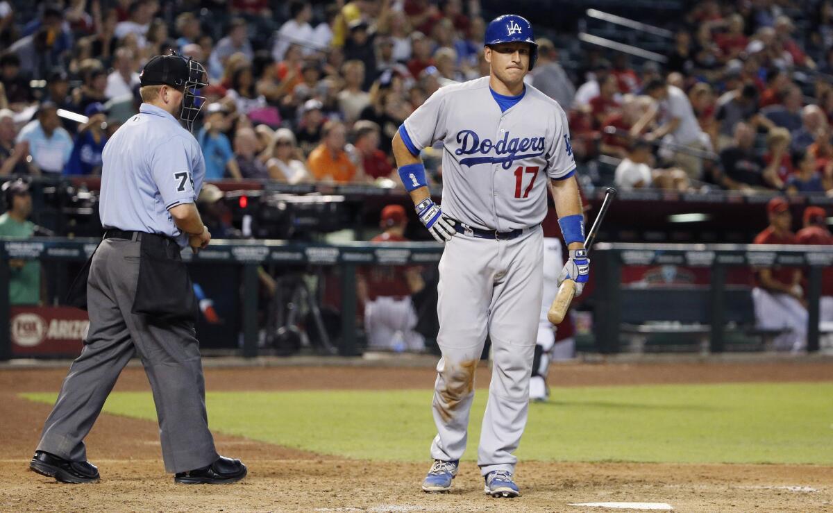Dodgers catcher A.J. Ellis walks back to the dugout after striking out against the Diamondbacks earlier this month.