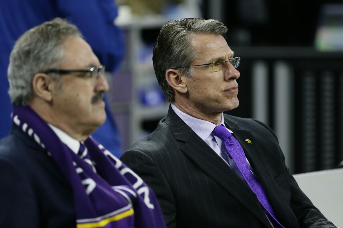 FILE - Minnesota Vikings chairman and co-owner Zygi Wilf, left, and General Manager Rick Spielman watch from the bench during pregame of an NFL football game against the Detroit Lions, Thursday, Nov. 23, 2017, in Detroit. The Minnesota Vikings fired general manager Rick Spielman and head coach Mike Zimmer on Monday, Jan. 10, 2022, according to a person with knowledge of the decision, after a second straight absence from the playoffs. The person spoke on condition of anonymity because the Vikings had not yet made the announcement. (AP Photo/Duane Burleson, File)