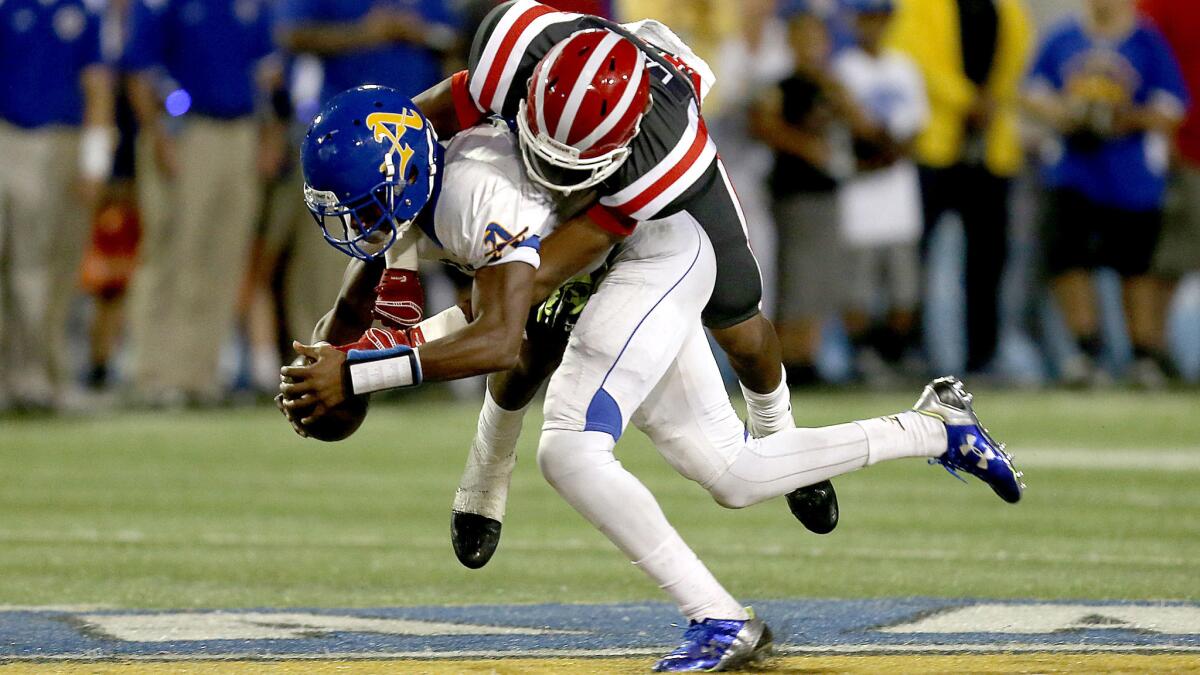 Bishop Amat wide receiver Tyler Vaughns hauls in a pass against Mater Dei defensive back Quentin Lake last season.
