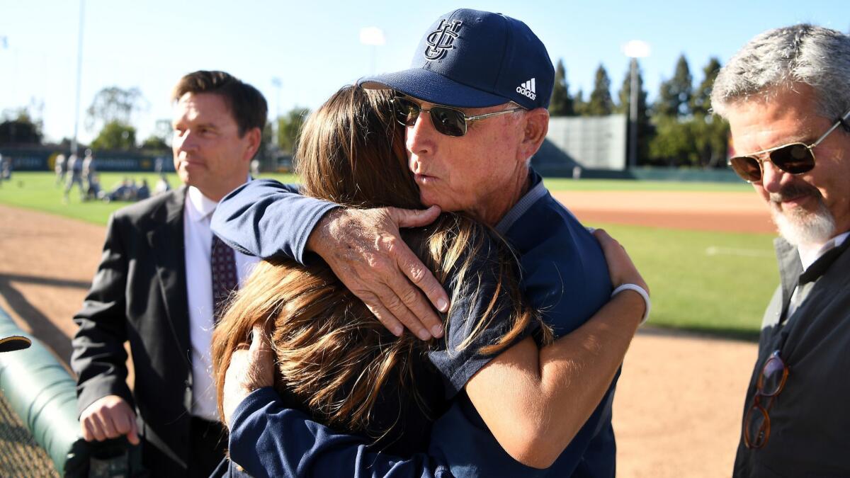 UC Irvine coach Mike Gillespie receives a hug from a family member before a game against USC.