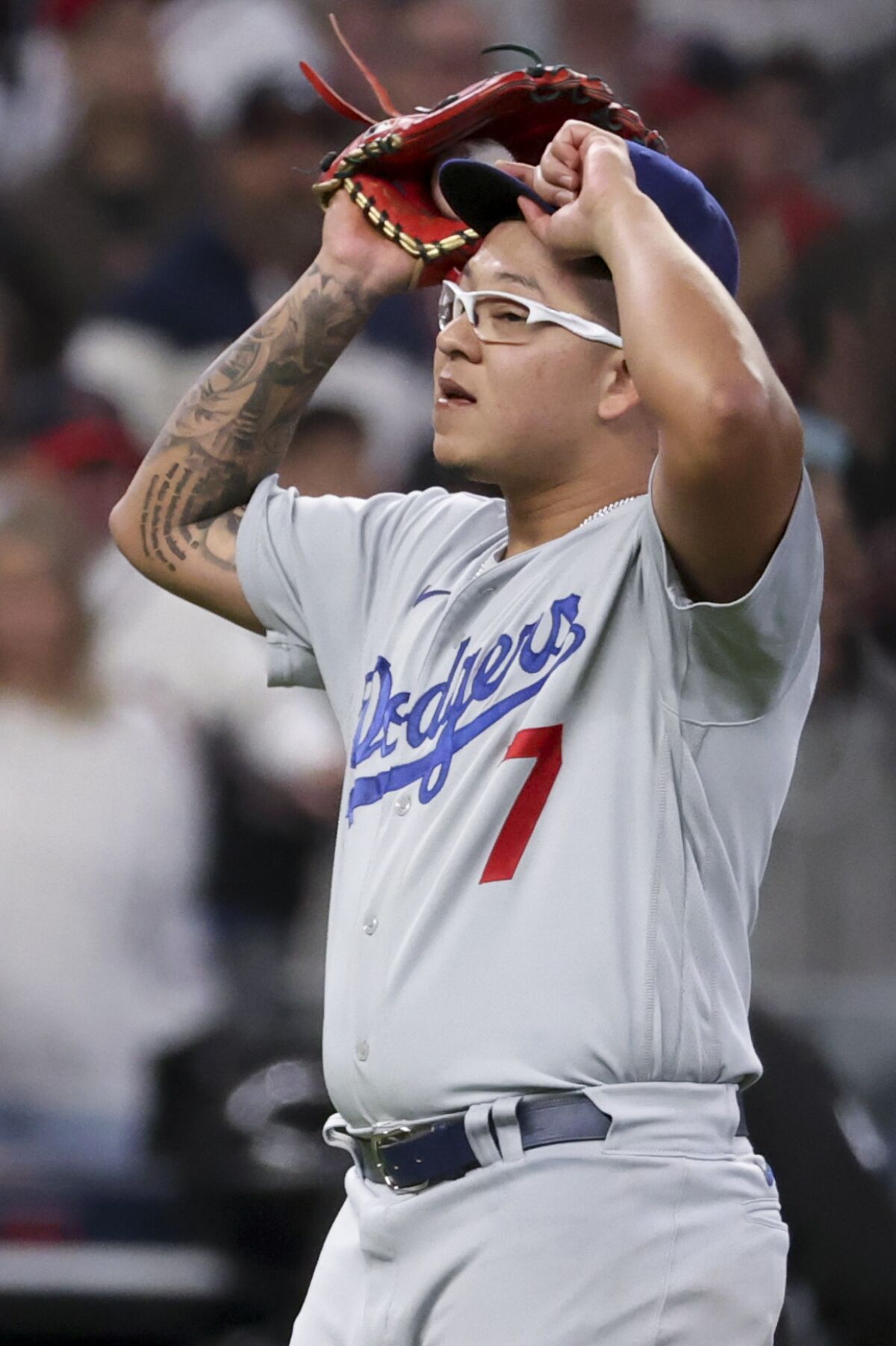 Dodgers pitcher Julio Urías reacts after giving up a run-scoring single to Atlanta's Ozzie Albies.