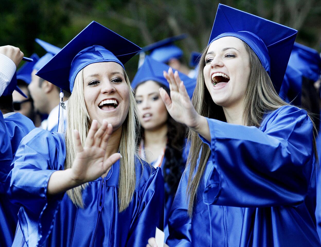 Courtney Laurent, 18, and Cassidy LaPenna, 18, sing Vitamin C's Graduation (Friends Forever) at the Burbank High School's graduation at the Starlight Bowl in Burbank.