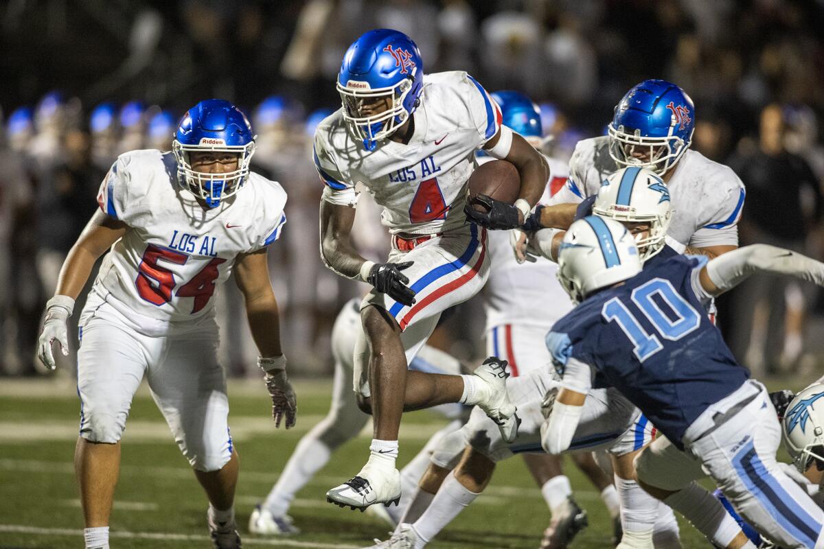 Los Alamitos' Damien Henderson runs for a touchdown during a Sunset League game against Corona del Mar at Davidson Field.