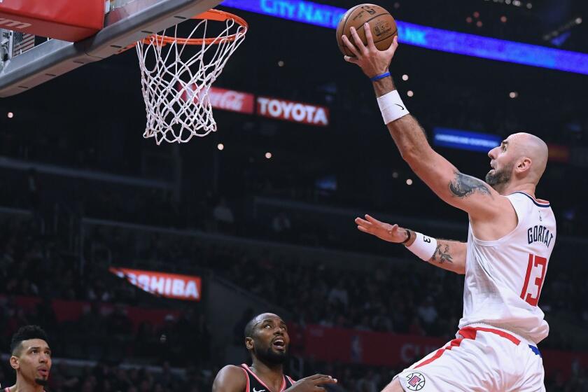 LOS ANGELES, CA - DECEMBER 11: Marcin Gortat #13 of the LA Clippers scores on a layup past Serge Ibaka #9 of the Toronto Raptors during the first half at Staples Center on December 11, 2018 in Los Angeles, California. NOTE TO USER: User expressly acknowledges and agrees that, by downloading and or using this photograph, User is consenting to the terms and conditions of the Getty Images License Agreement. (Photo by Harry How/Getty Images) ** OUTS - ELSENT, FPG, CM - OUTS * NM, PH, VA if sourced by CT, LA or MoD **