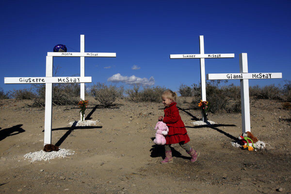 Friends and family of the McStay family, whose remains were found buried in shallow graves in the desert near Victorville, have set up crosses memorializing them.