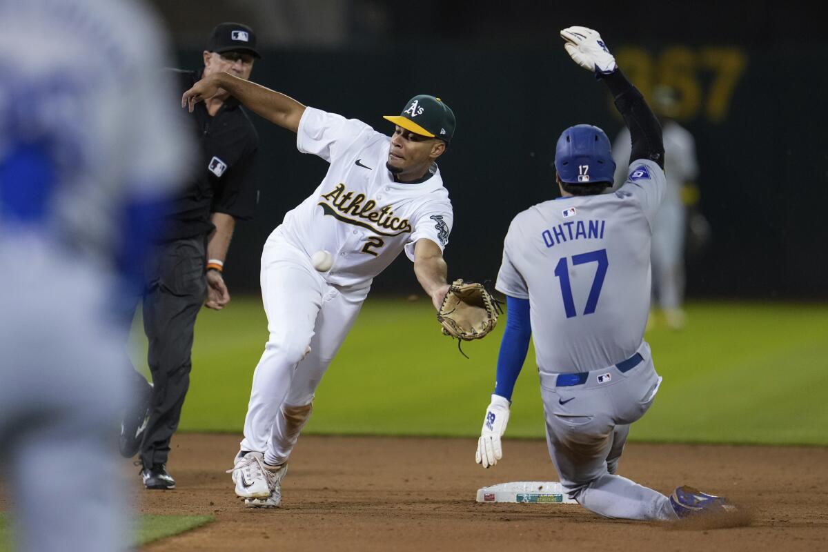 Athletics second baseman Darell Hernaiz is unable to catch a throw as Dodger Shohei Ohtani steals second 