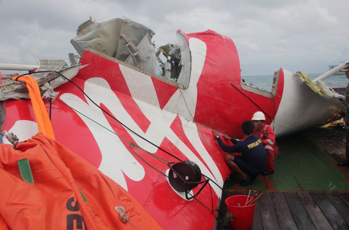 Officials examine wreckage from an AirAsia plane after it was lifted onto a ship on Jan. 10. The jetliner crashed into the Java Sea with 162 people on board on Dec. 28, 2014.