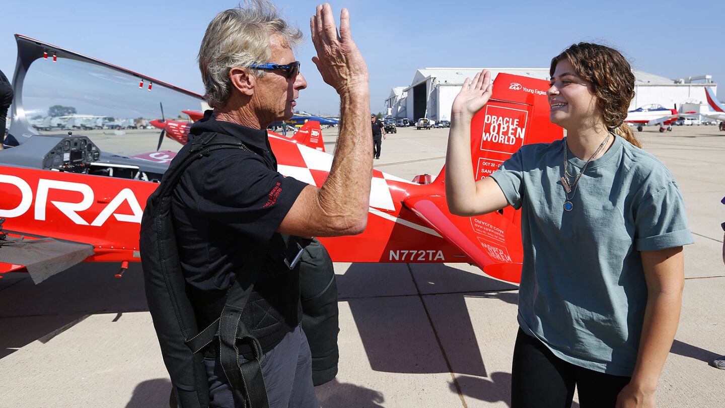 Stunt pilot Sean Tucker talks with Hannah Hollinger, 16, of El Cajon after a flight in his stunt plane at the MCAS Miramar Air Show on September 27, 2018. The flight was part of the EAA Young Eagle flight program which introduces kids to flight. Tucker is the chairman of the EAA Young Eagles. (Photo by K.C. Alfred/San Diego Union-Tribune)