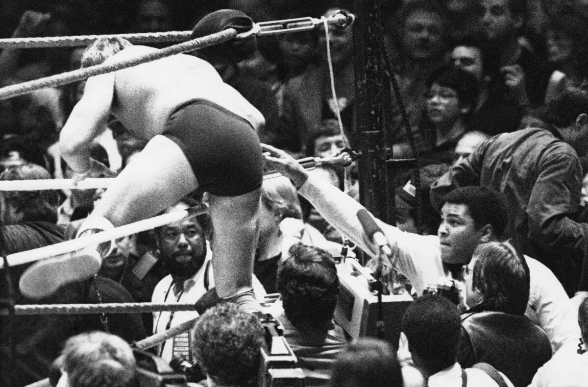 Guest referee Muhammad Ali tries to prevent "Rowdy" Roddy Piper from entering the ring illegally at Wrestlemania.