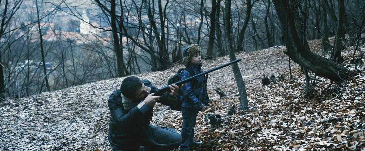 Two people, one with a gun, in a scene from the movie "R.M.N."