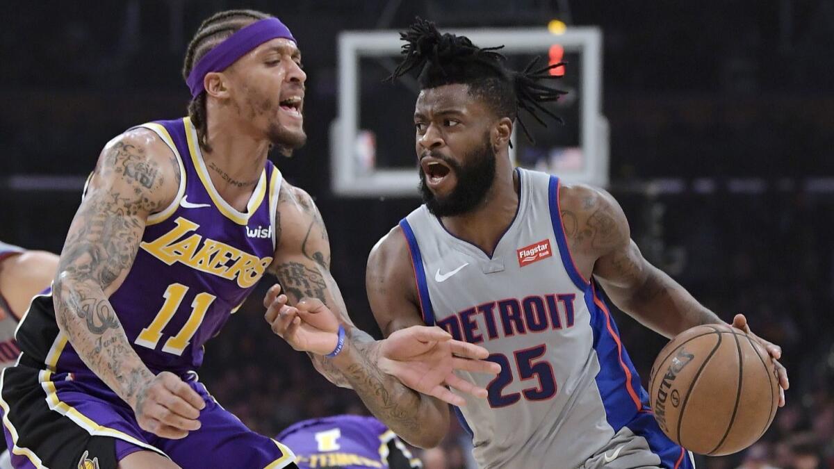Detroit guard Reggie Bullock (25) tries to drive past Lakers forward Michael Beasley on Jan. 9. The Lakers have agreed to acquire Bullock from the Pistons.