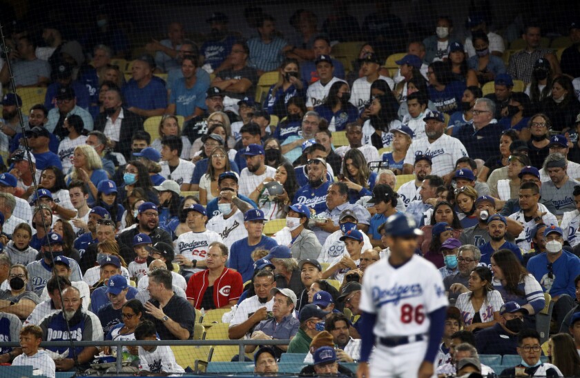 Very few fans wear masks in the stands as the Dodgers play the Mets at Dodger Stadium on Aug. 19.