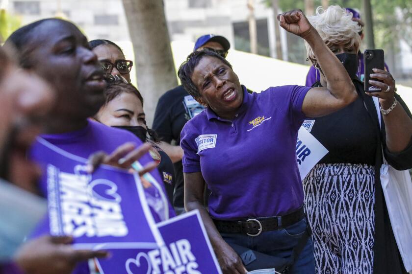 Los Angeles, CA - June 29: Mattie Ruffin, a nursing assistant at Kaiser, and others celebrate the final approval by Los Angeles City Hall to an ordinance raising the minimum wage for healthcare workers in the city to $25 per hour, at assembly session held at City Hall on Wednesday, June 29, 2022 in Los Angeles, CA. (Irfan Khan / Los Angeles Times)