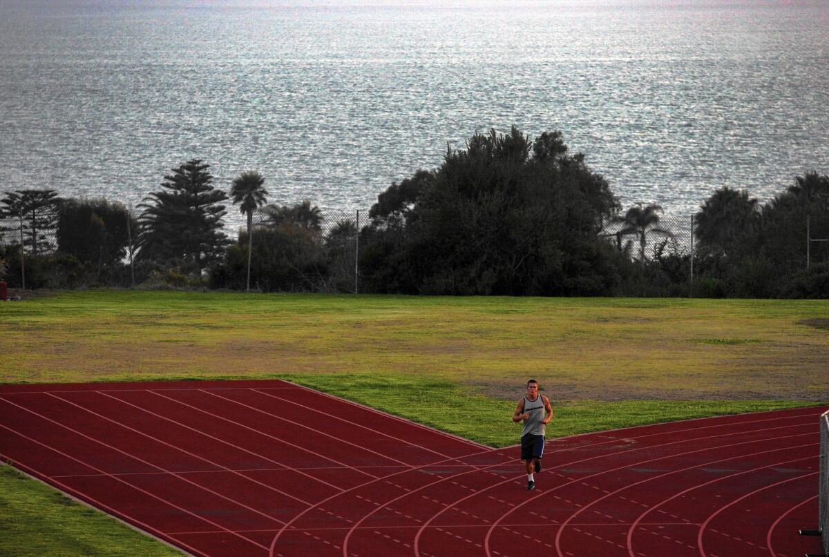 A runner makes his way around the Malibu High School track. A Los Angeles County Superior Court judge has denied a long-standing request by residents to block the use of 70-foot-tall stadium lights at the school.