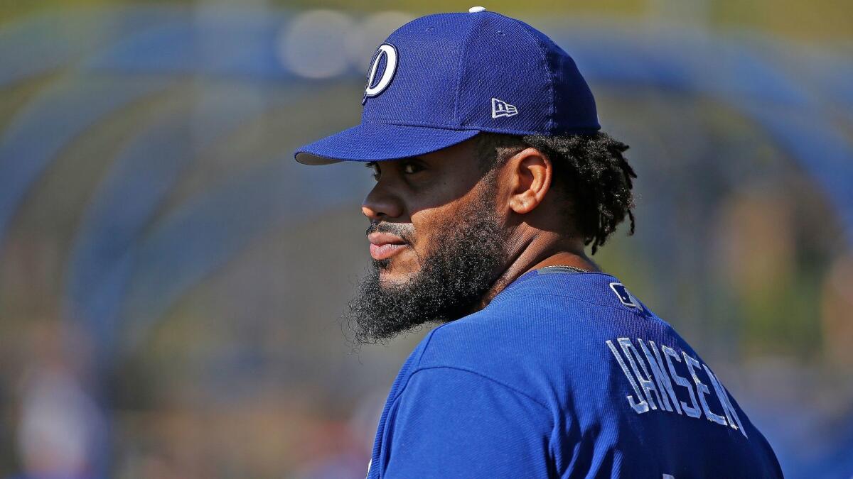 Dodgers pitcher Kenley Jansen watches teammates during infield drills on Feb. 21 in Glendale, Ariz.