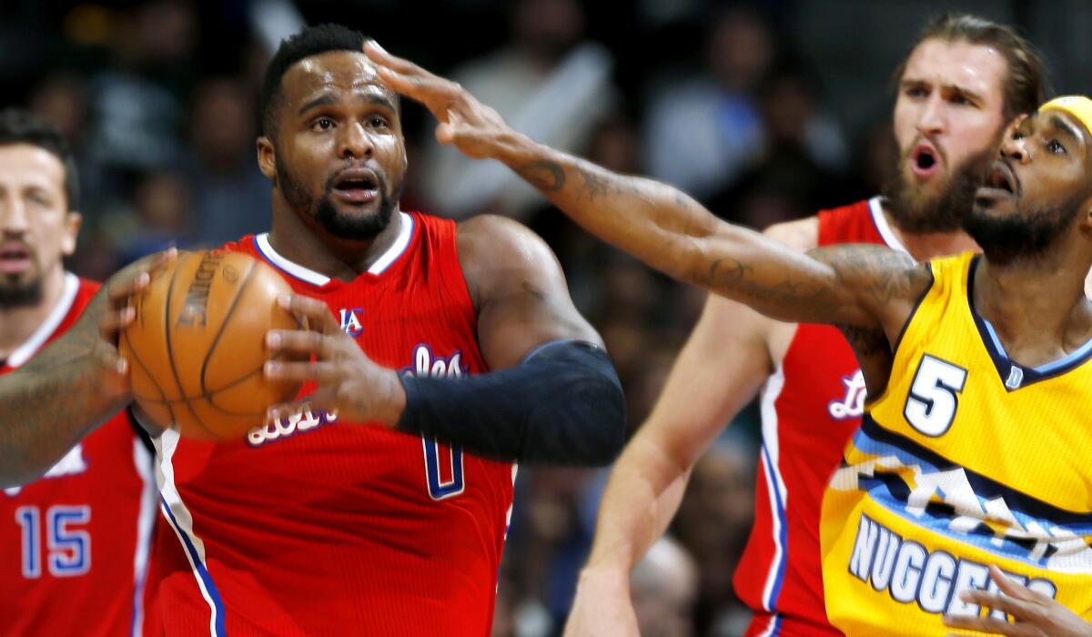 Clippers forward Glen Davis pulls down a loose ball against Nuggets forward Will Barton in the first half Saturday night in Denver.