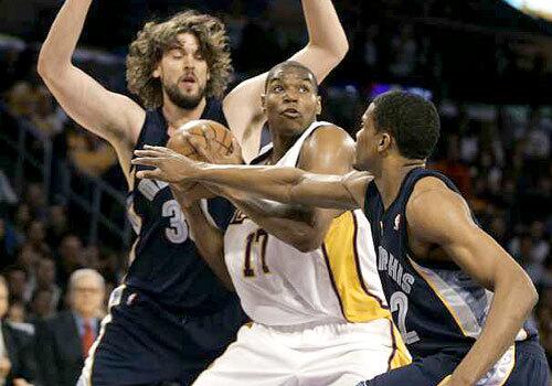 Lakers center Andrew Bynum makes a move in the post between Grizzlies center Marc Gasol and forward Rudy Gay during the first half Sunday.