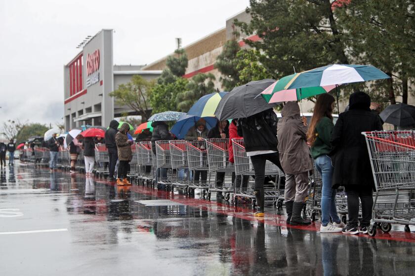 Hundreds of customers lined up on three sides of the Costco building before doors opened, most looking for water, toilet paper, paper towels and cleaning supplies in Burbank on Friday, March 13, 2020. A continual flow of single-file customers entered the store for thirty-minutes although more customers continued to arrive throughout the morning. Water and other necessities were out of stock within 20 minutes after the store opened. According to a manager on site who did not give his name, an entire truckload of water was scooped up by customers in less than half an hour.