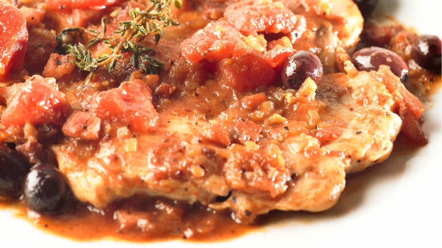 Chicken breasts are topped with a sauce of tomatoes, olives, herbs and rich pancetta. Recipe: Basque-style chicken