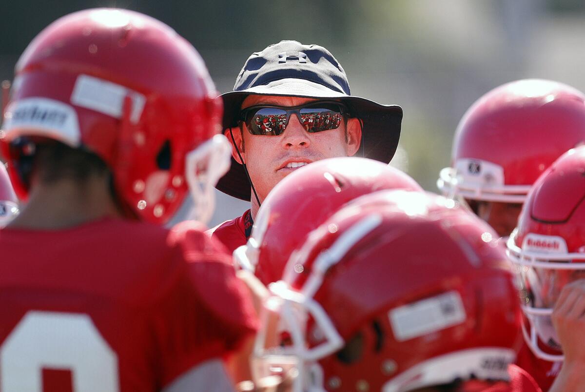 Coach Rand Holdren and the Burroughs High football team took on La Palma Kennedy in a nonleague game Thursday.