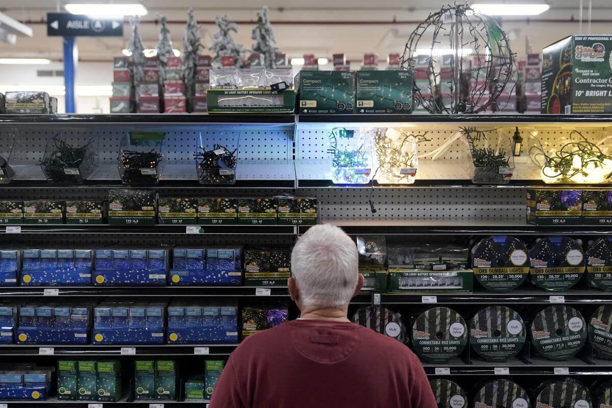 A customer browses the holiday lights section in a store