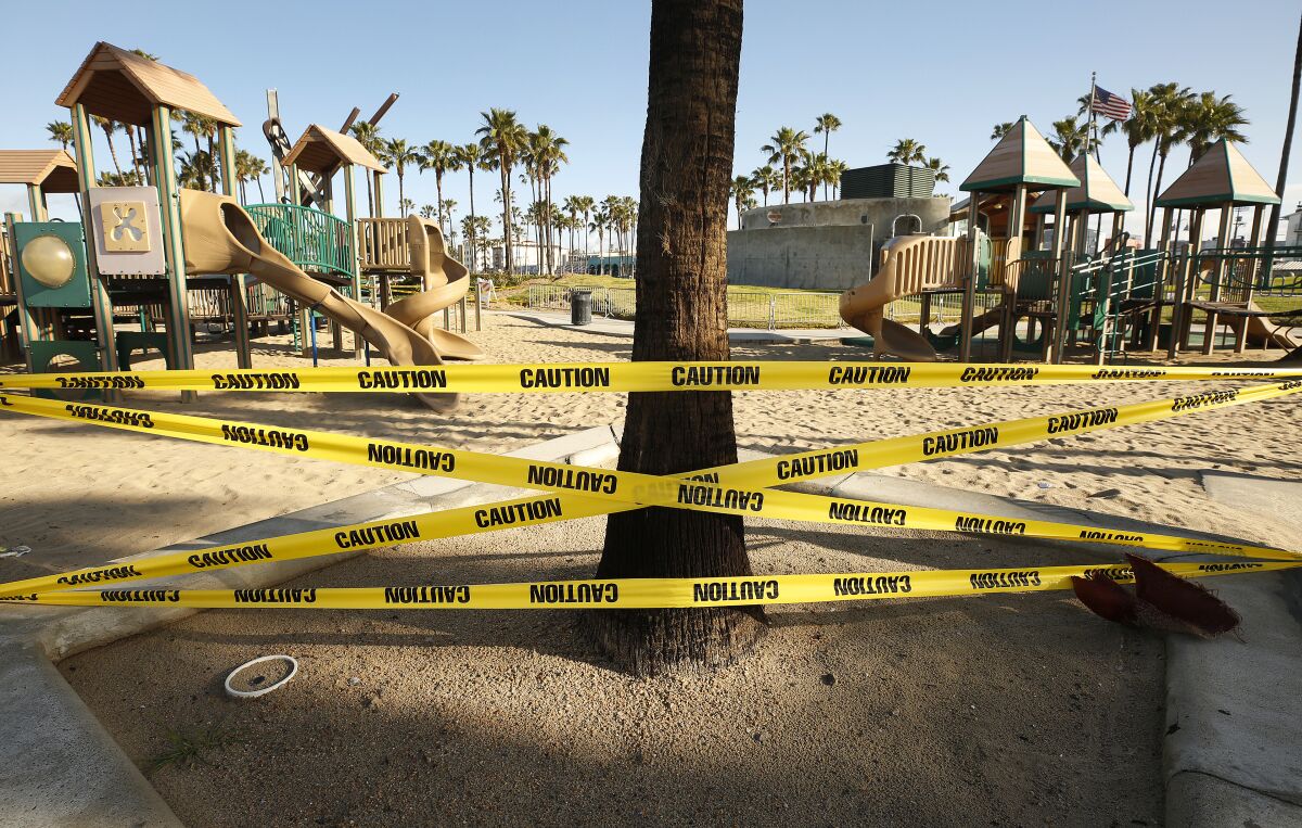 A playground cordoned off with caution tape
