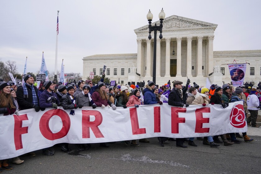 People participate in the March for Life outside the U.S. Supreme Court on Capitol Hill in Washington, Friday, Jan. 21, 2022. (AP Photo/Patrick Semansky)