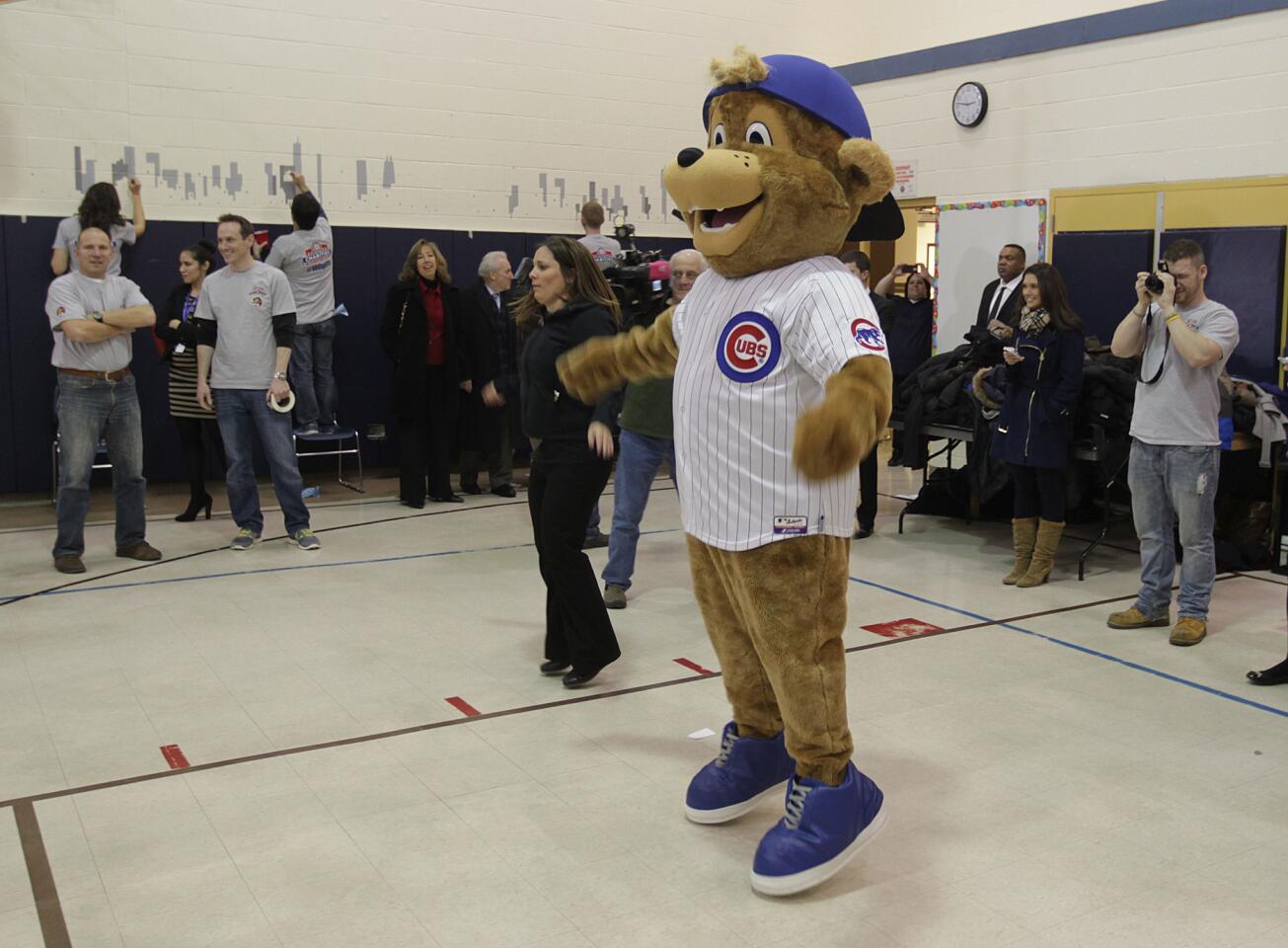 New mascot "Clark" does some jumping- jacks with the kids.