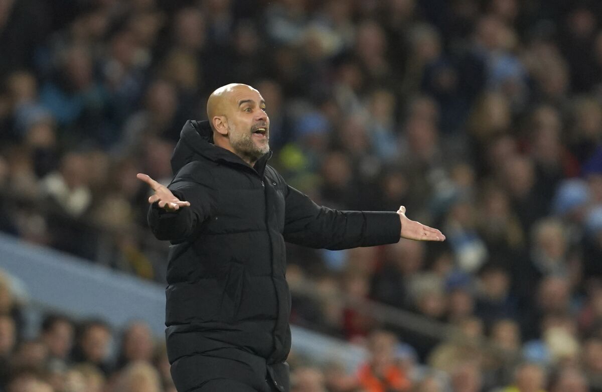 Manchester City's head coach Pep Guardiola reacts during the English Premier League soccer match between Manchester City and Leeds United at Etihad stadium in Manchester, England, Tuesday, Dec. 14, 2021. (AP Photo/Jon Super)